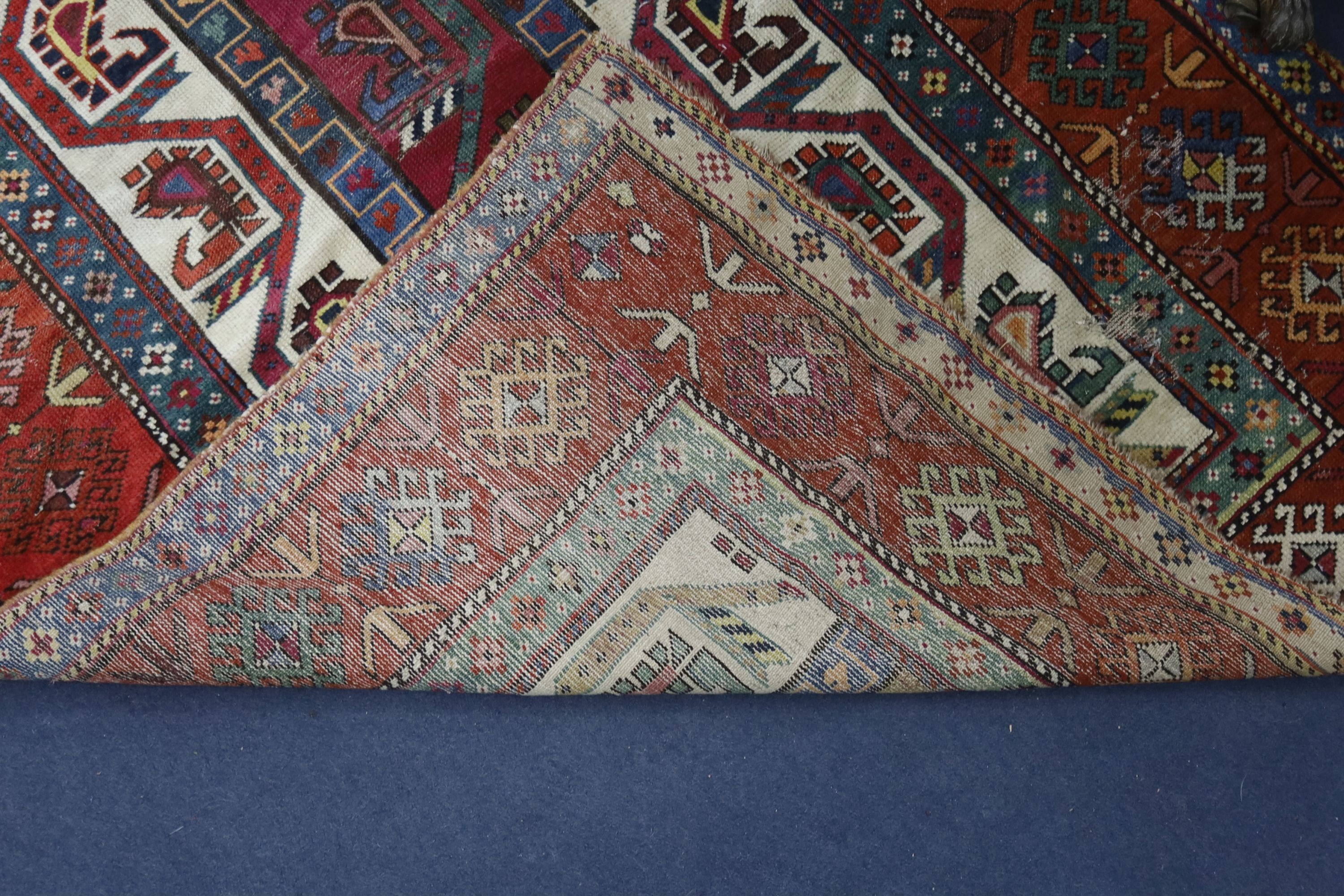 A Caucasian geometric rug, 284 x 118cm